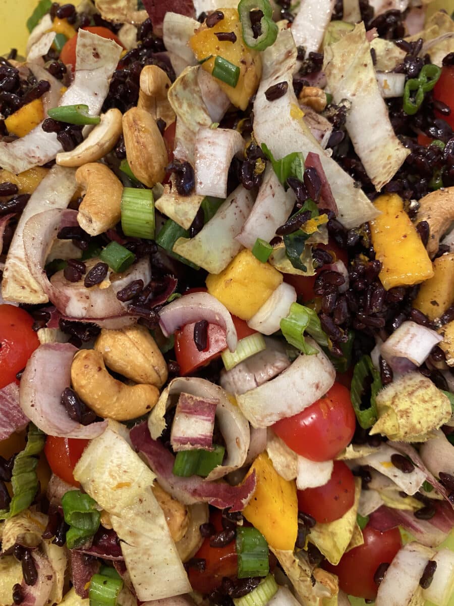 Black rice salad with chopped vegetables, cashews, and coconut lime dressing