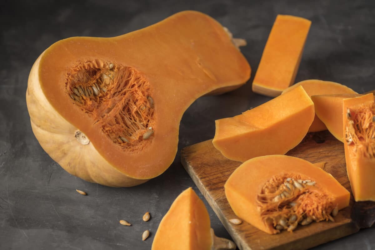 Halved butternut squash with seeds and fiber