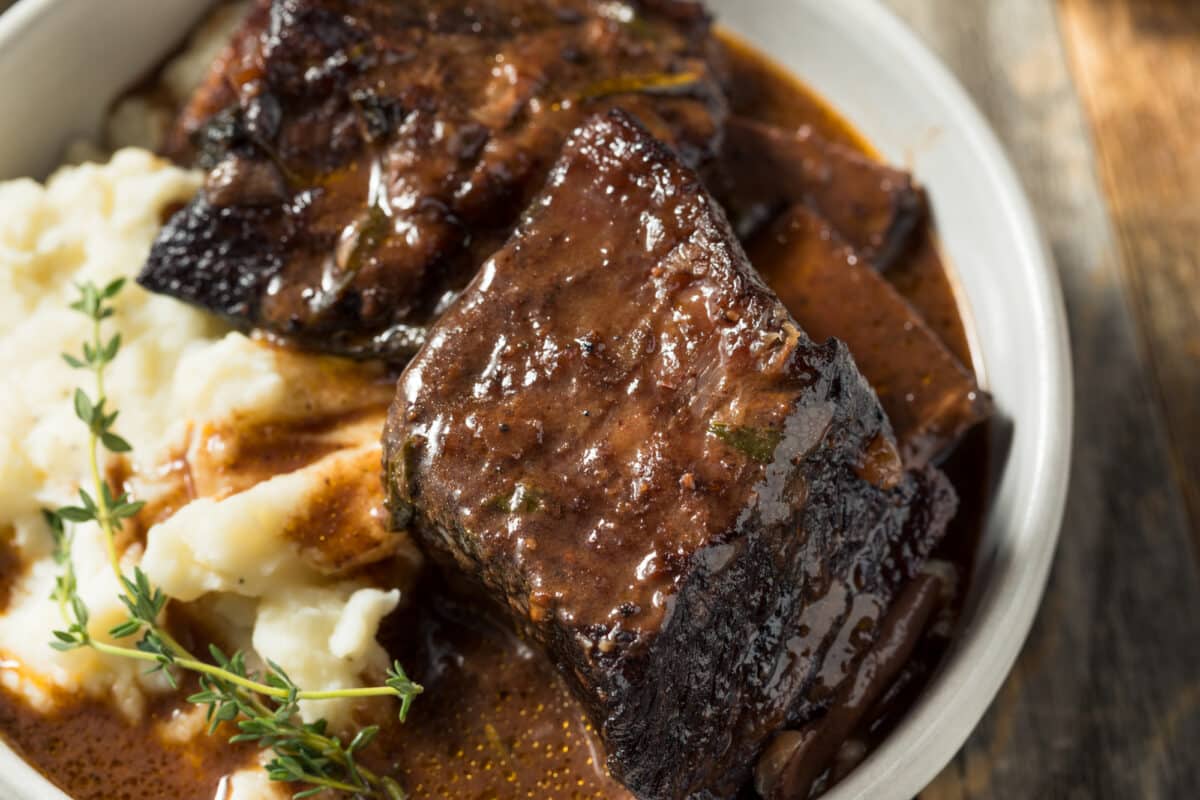 Braised beef short ribs with mashed potato and gravy.