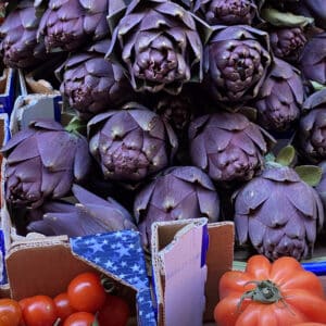 Market in Italy with artichokes and tomatoes