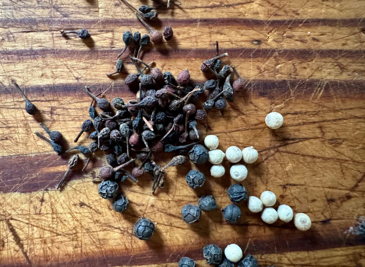 scattered peppercorns on a wooden table