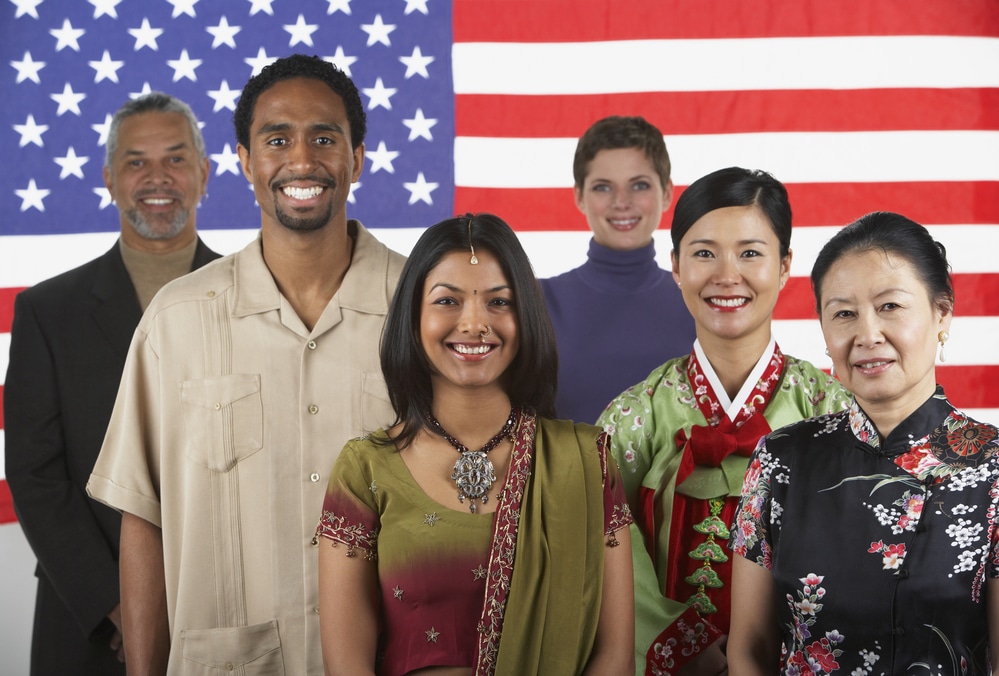 A group of individuals standing in front of the American flag.