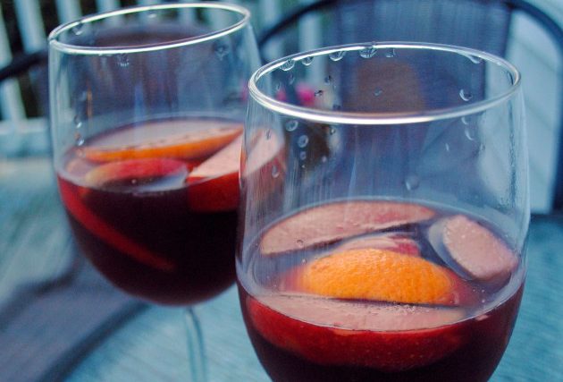Two glasses of cider sangria with fruit slices