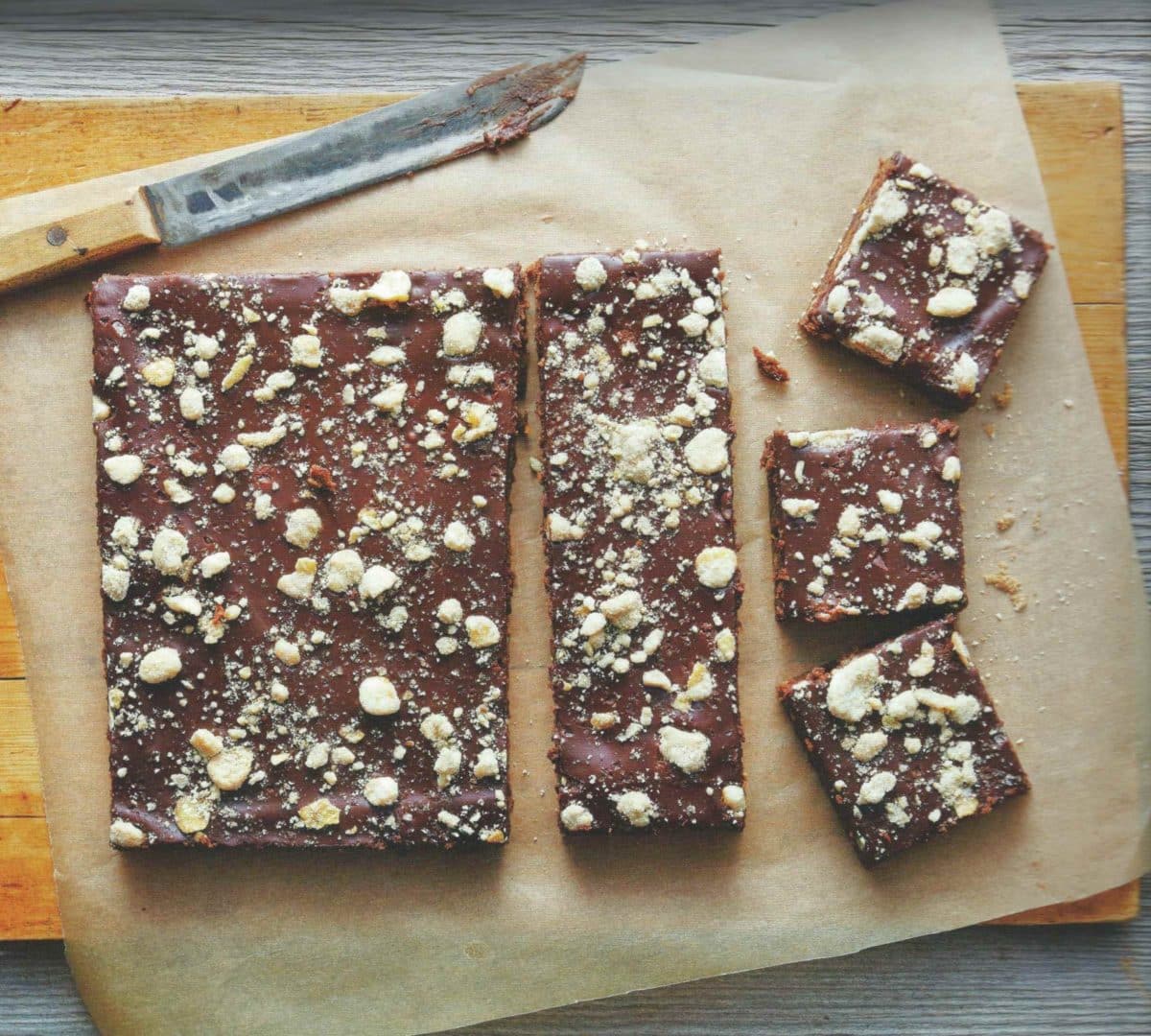 Freshly sliced Banana Crunch Beer Brownies on parchment paper