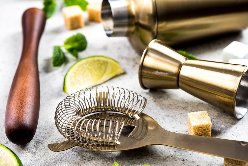 Set of bartender tools with a wooden handle and lime slices