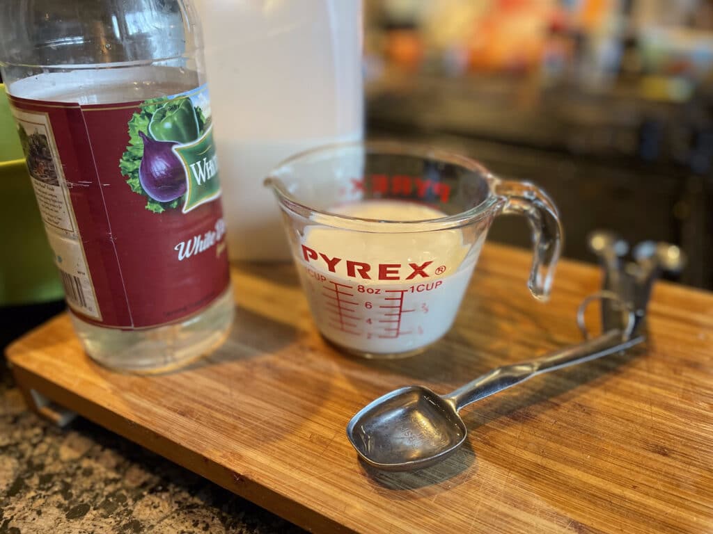 measuriing cup of milk and vinegar to make buttermilk