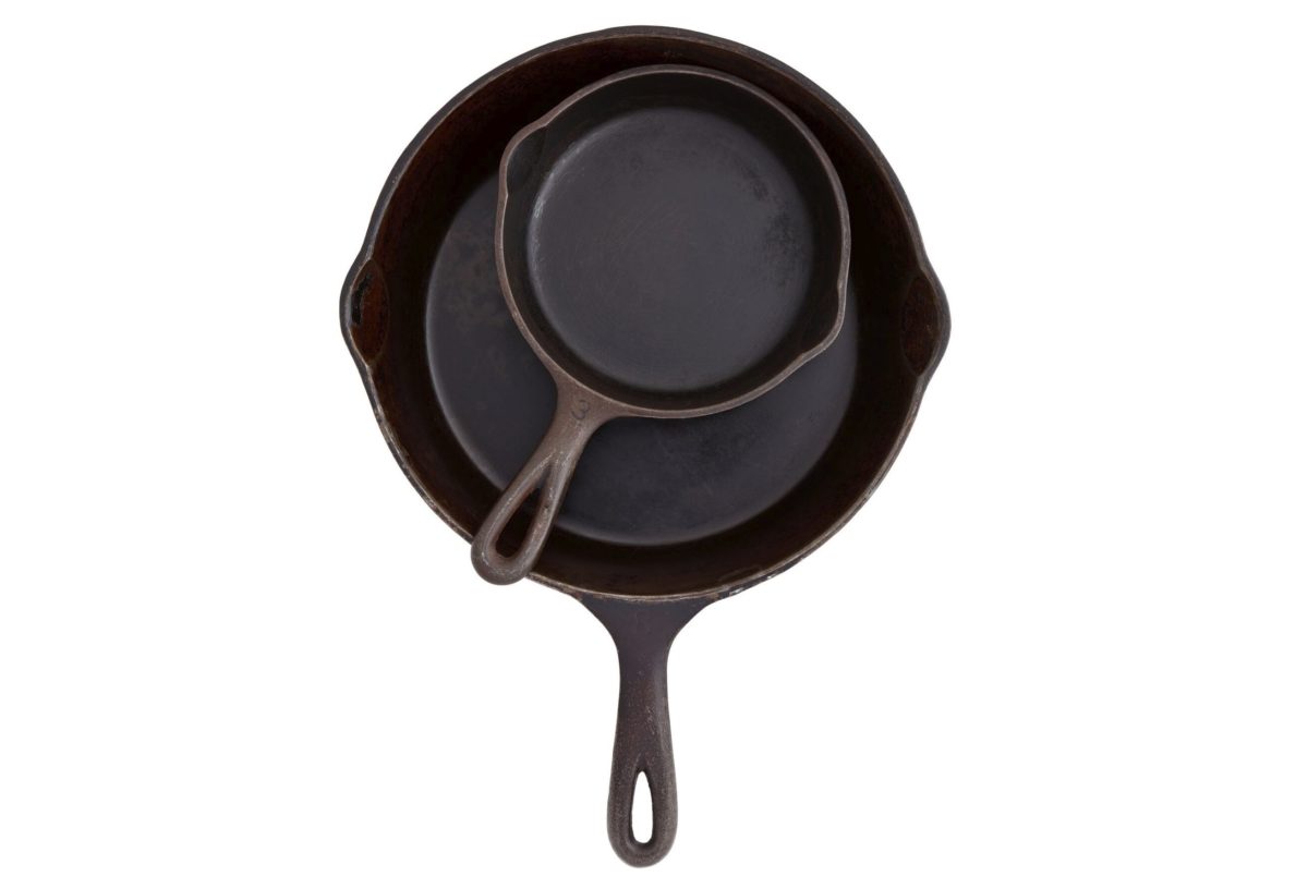 A top view of cast iron pans nested together.