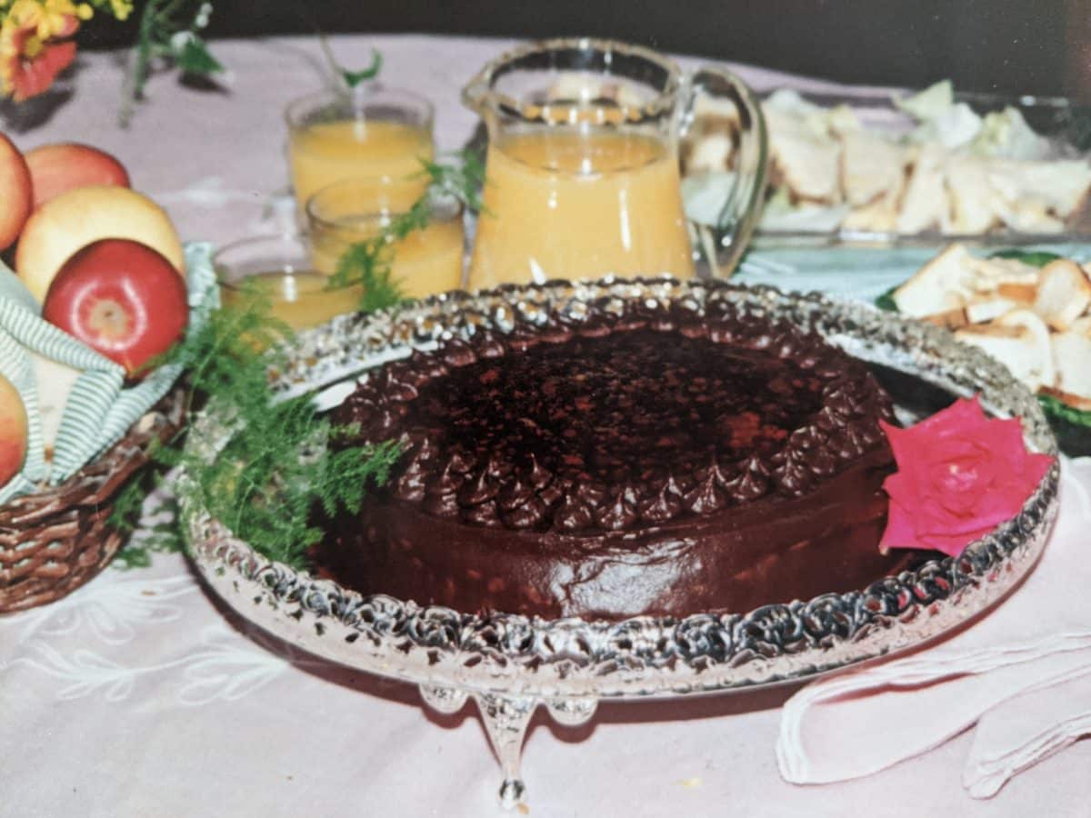Chocolate cake with fresh fruit and beverages around