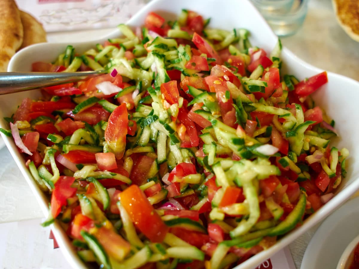 Freshly cut vegetables mixed together in a vibrant classic Israeli salad.