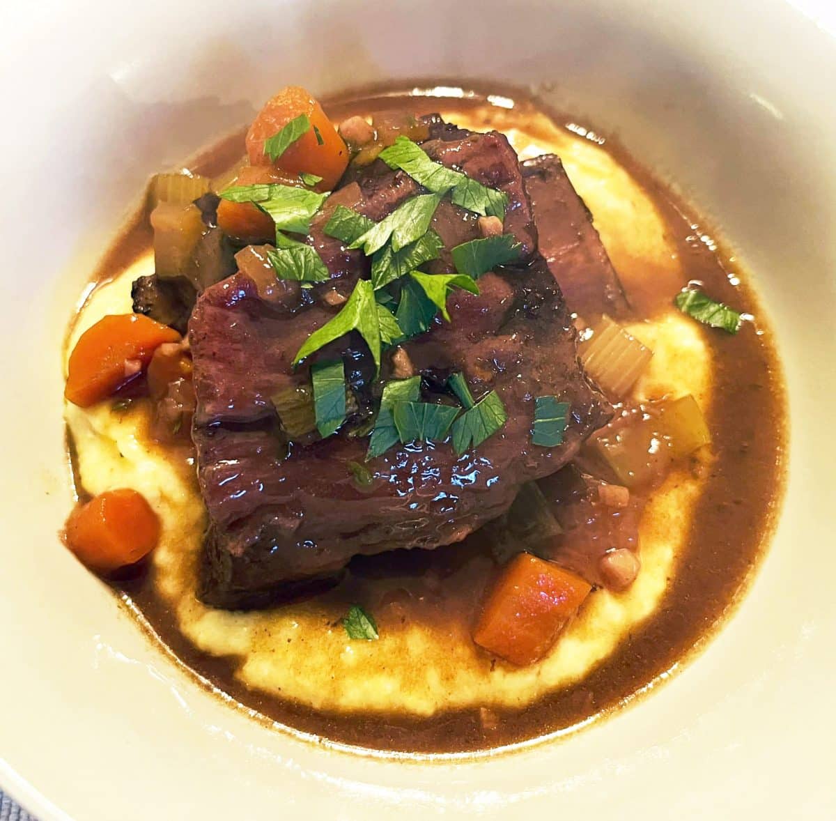 Close-up view of cola braised short ribs with garnishing