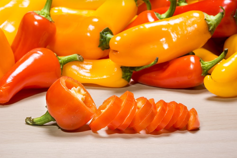 Freshly sliced mini bell peppers on a chopping board
