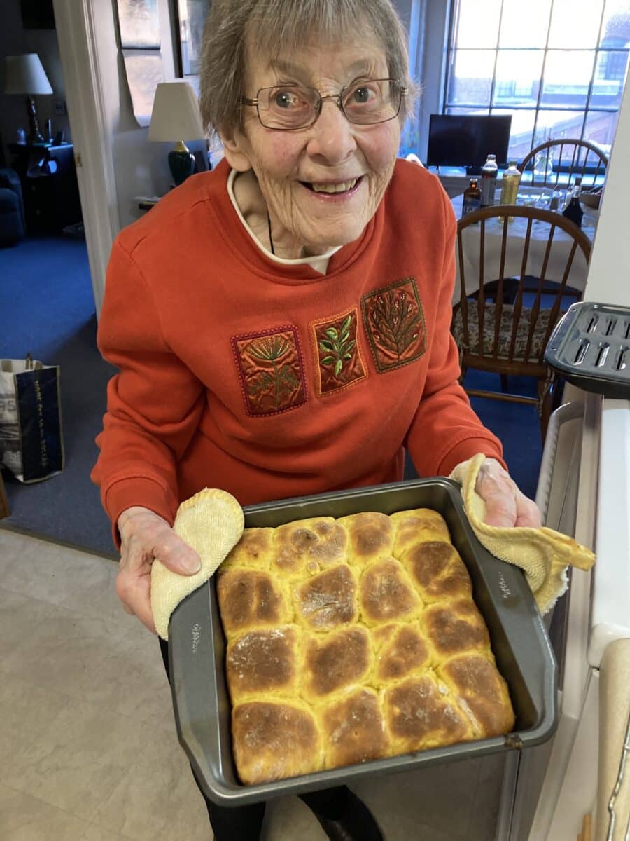 woman with pan of rolls