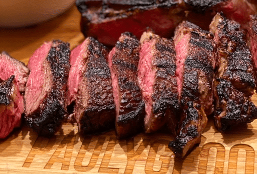 Grilled rib-eye steak sliced to reveal its juicy inside