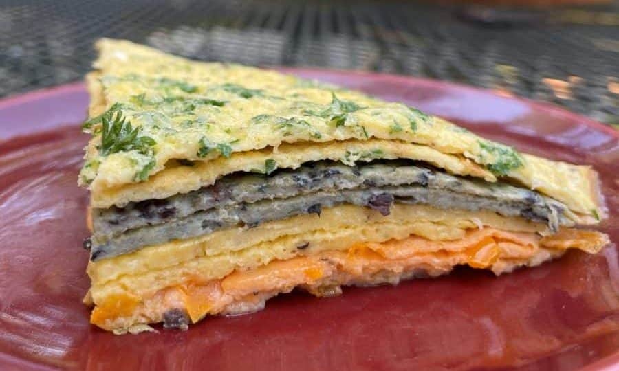 A slice of Crespéou, showcasing its layered ingredients.