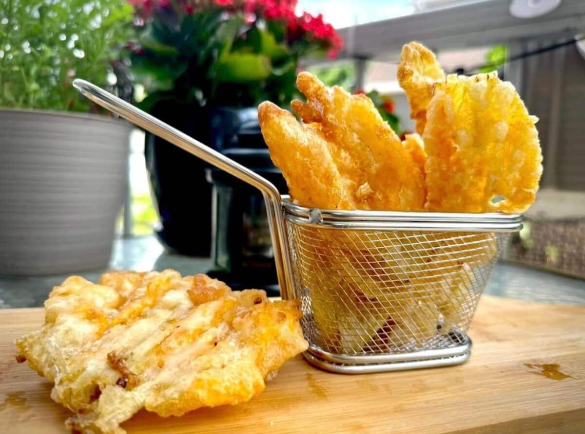 Crispy zucchini flowers in a deep fry basket
