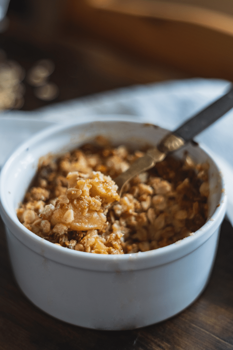 Close-up of a baked apple crisp with spoon