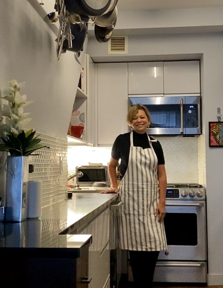 Denise Landis smiling in her New York City kitchen