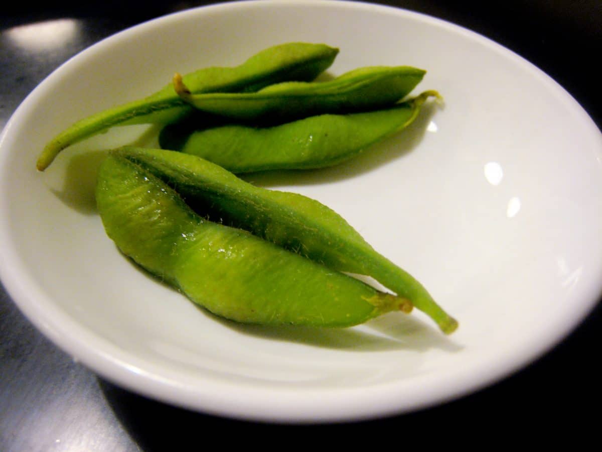 Fresh green edamame on a white plate