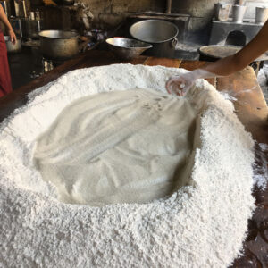 Large mound of white flour on wooden table