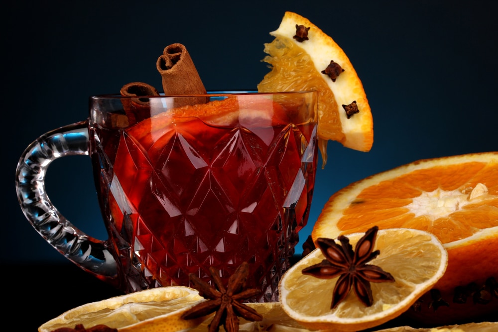 Fragrant mulled wine in a glass with slices of oranges and spices.