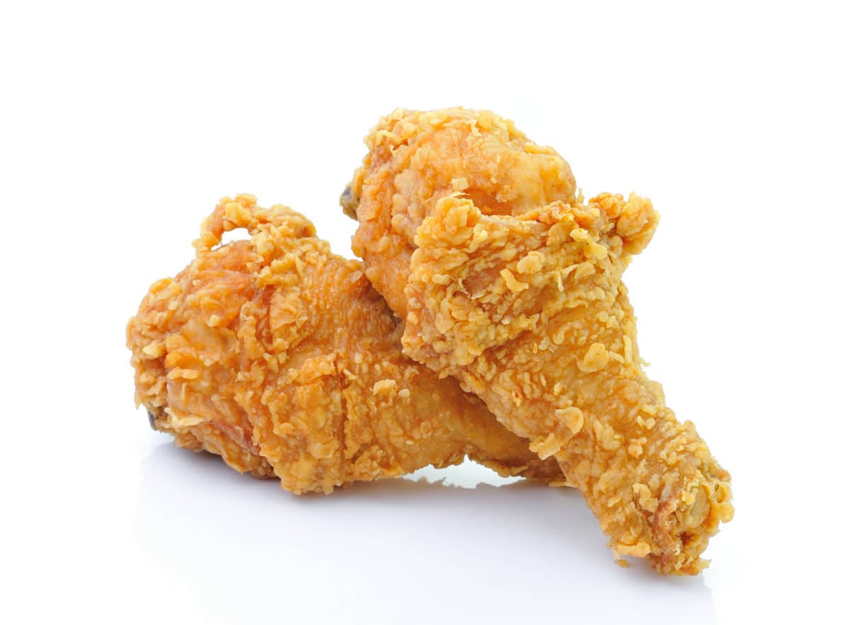 Golden fried chicken pieces on a white background