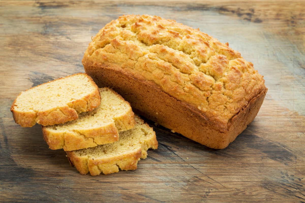 A loaf of acorn bread with a few slices laid out.