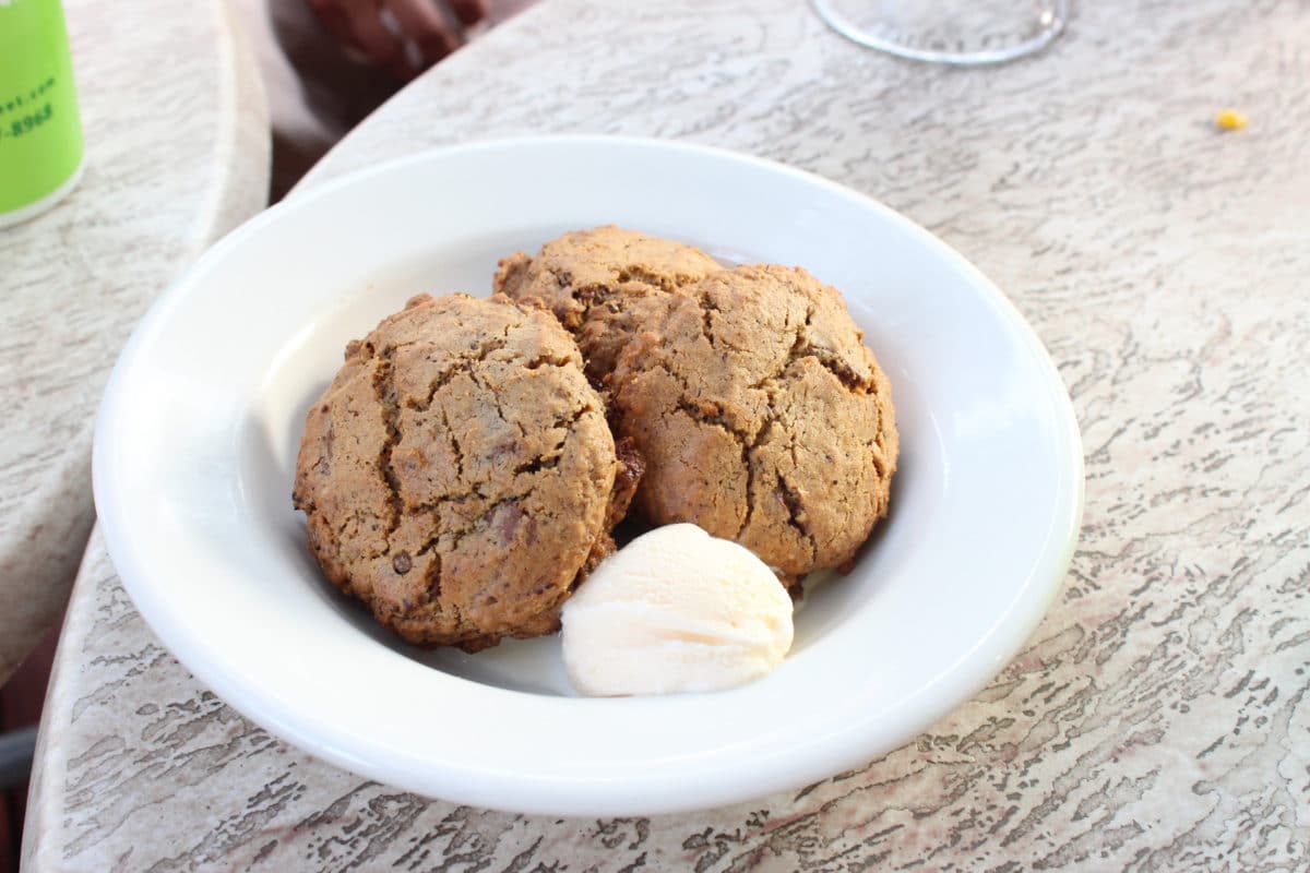 Plate of Chocolate Chirp Cookies with a scoop of cream.