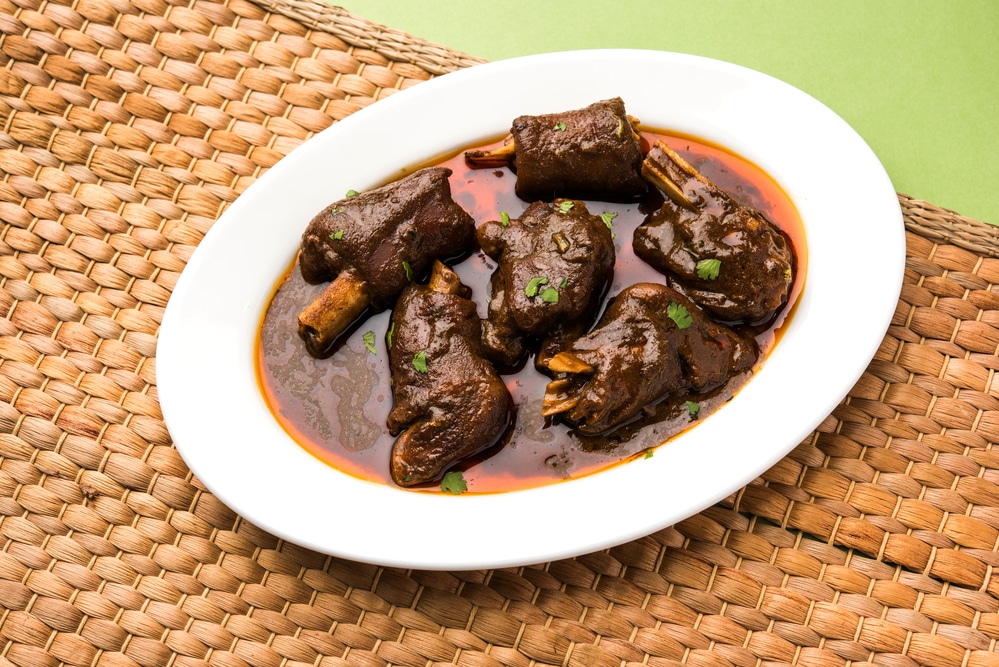 Hearty goat meat soup served on a plate
