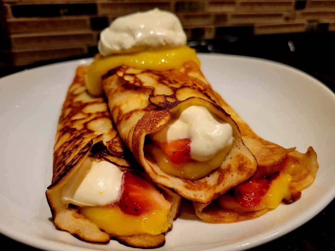 Fresh lemon curd crepes with strawberries and lemon whipped cream