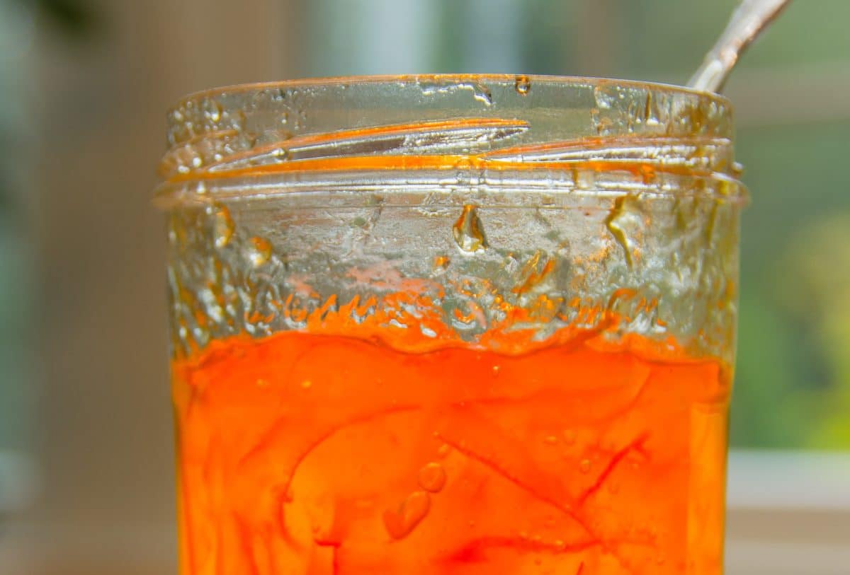 Close-up of orange marmalade in a glass jar
