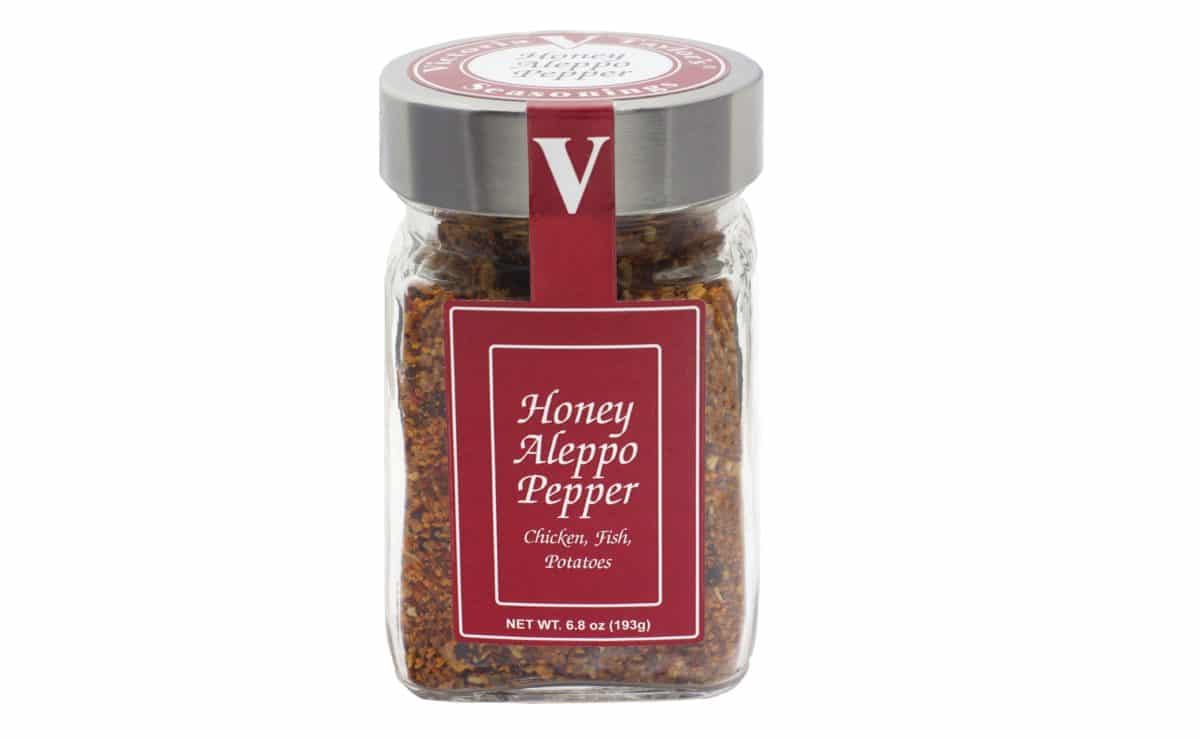 A sealed jar labeled "Honey Aleppo Pepper" suitable for chicken, fish, and potatoes.