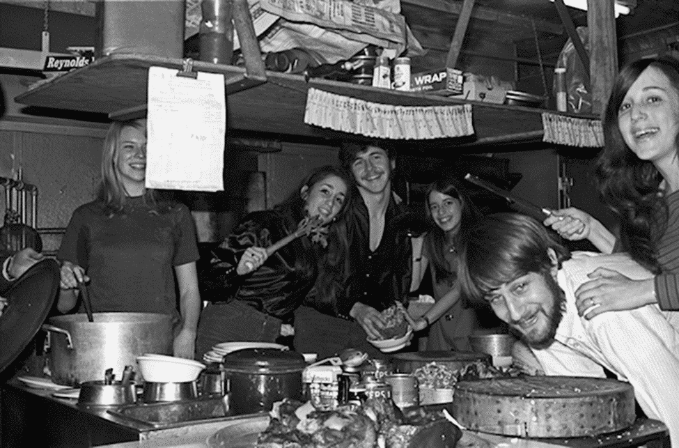 Two women holding utensils in a playful manner at Hwa Yuan's kitchen.