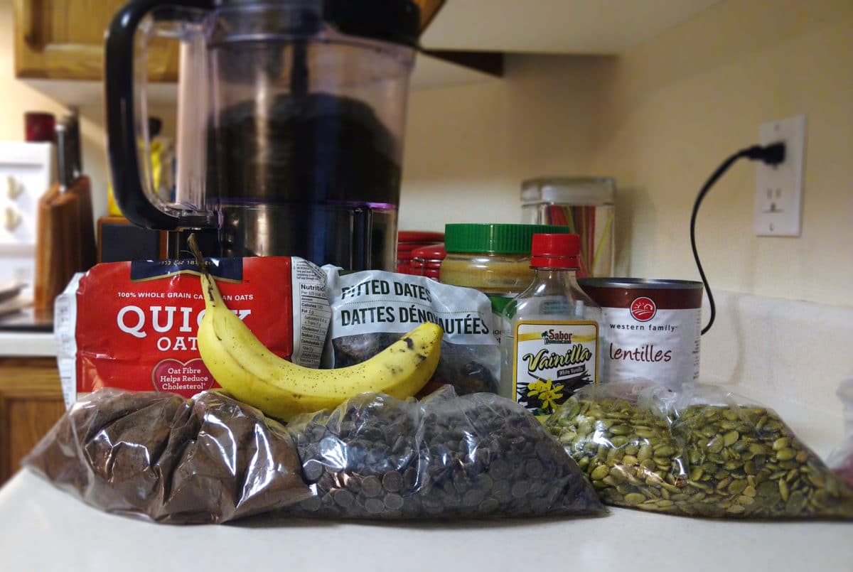 Assorted ingredients including oats, dates, and lentils displayed on a kitchen counter