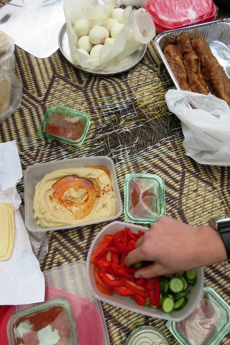 A variety of breakfast items set up for an Israeli picnic.