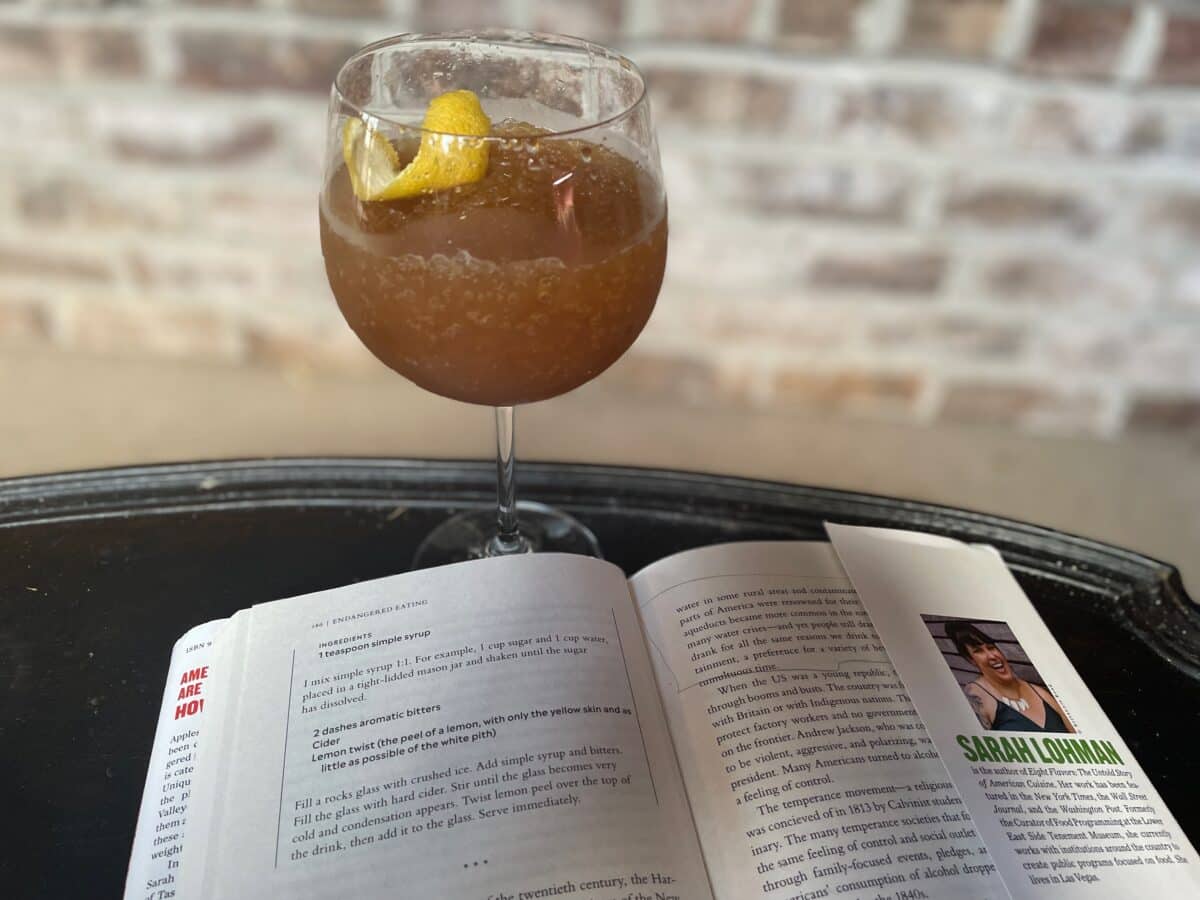 Glass of cider with bitters and lemon pee;