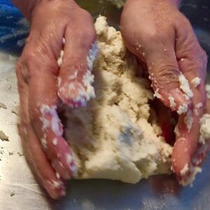 Hands kneading masa dough