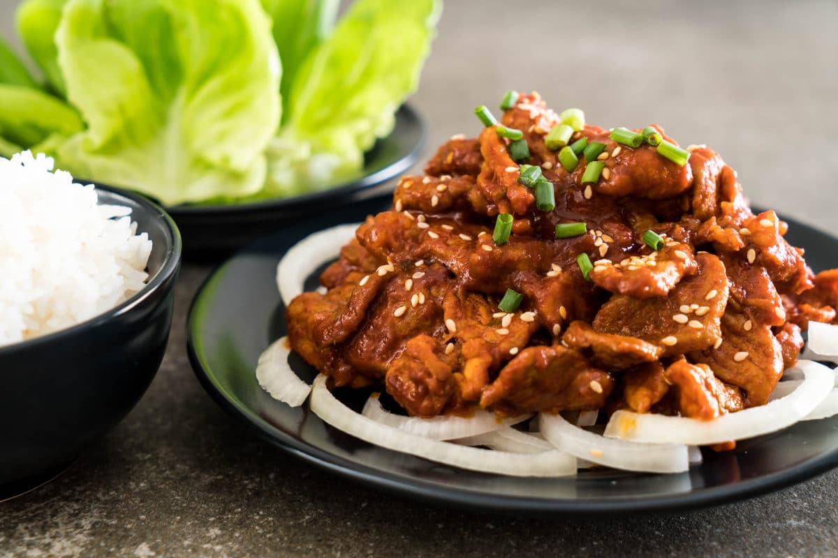 Close-up of fried pork with spicy Korean sauce and white rice
