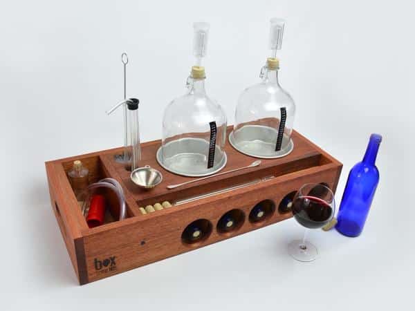 Box Brew Kits mahogany wine-making kit with empty bottles and instruments.