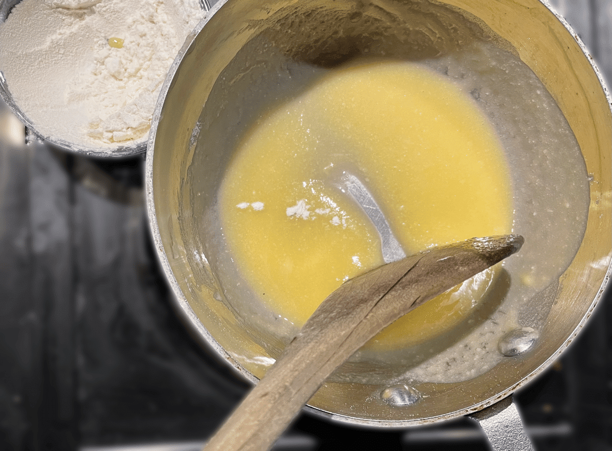 Melted butter being mixed with flour to create a roux.