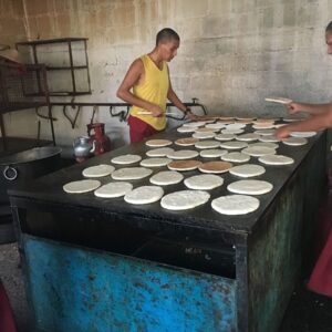 Man standing near a grill, cooking pah lay