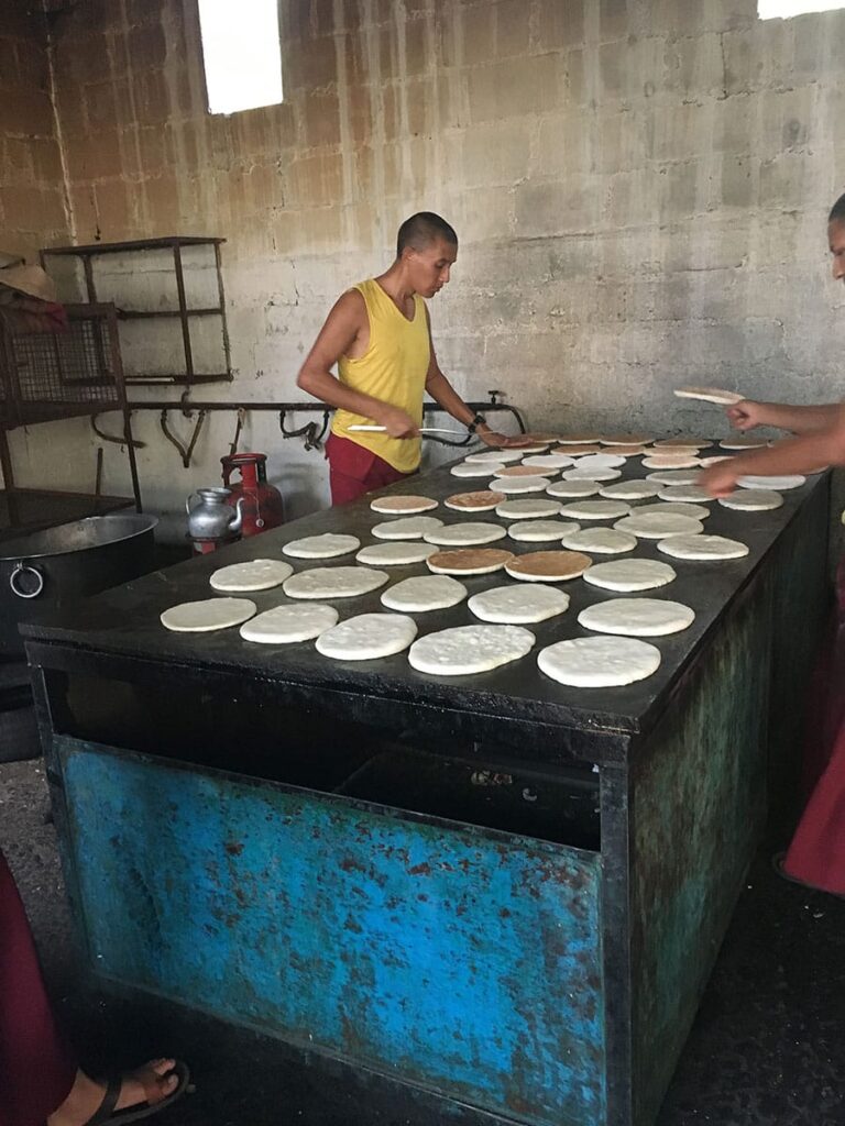 Man standing near a grill, cooking pah lay