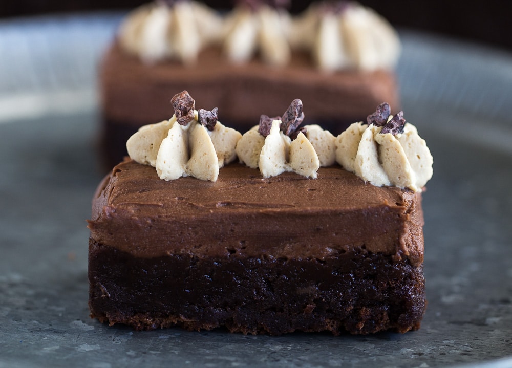A delectable miso brownie topped with cream and chocolate.