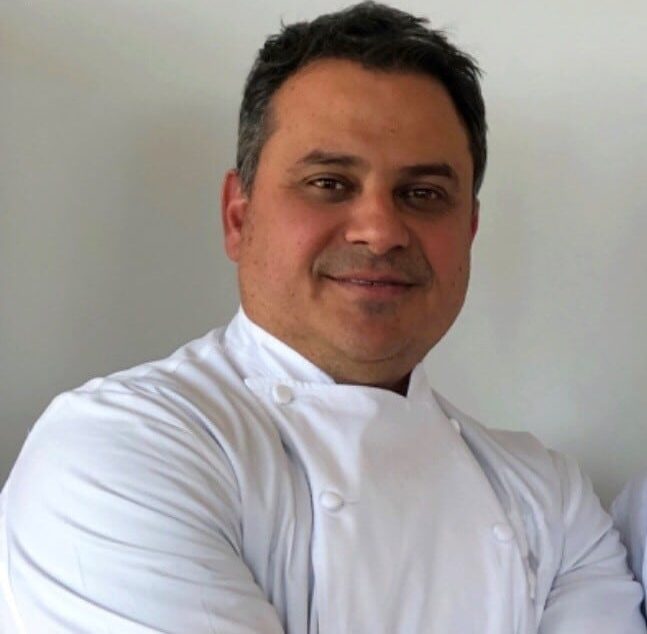 Professional headshot of Nick Calias in chef attire