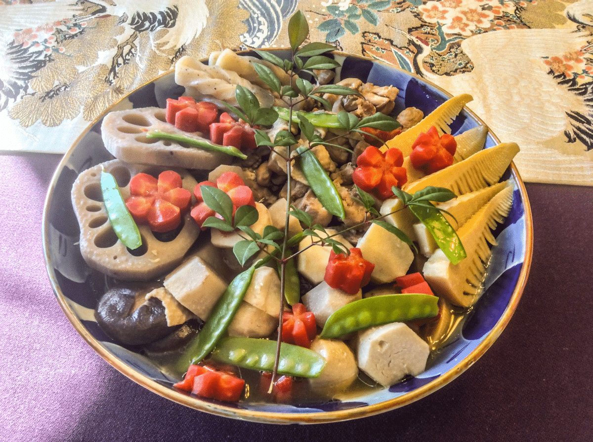 Assorted simmered chicken and vegetables in a decorative bowl.