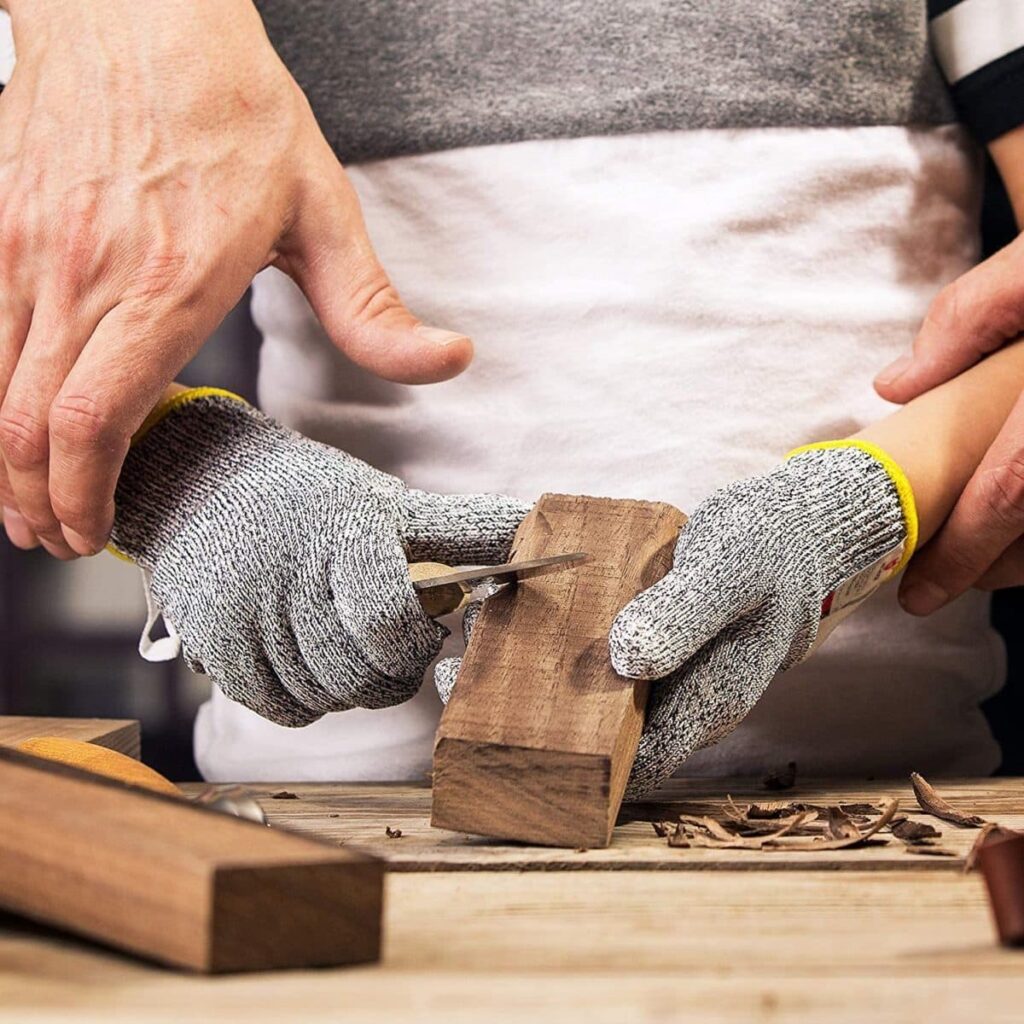 Hands wearing cut resistant gloves