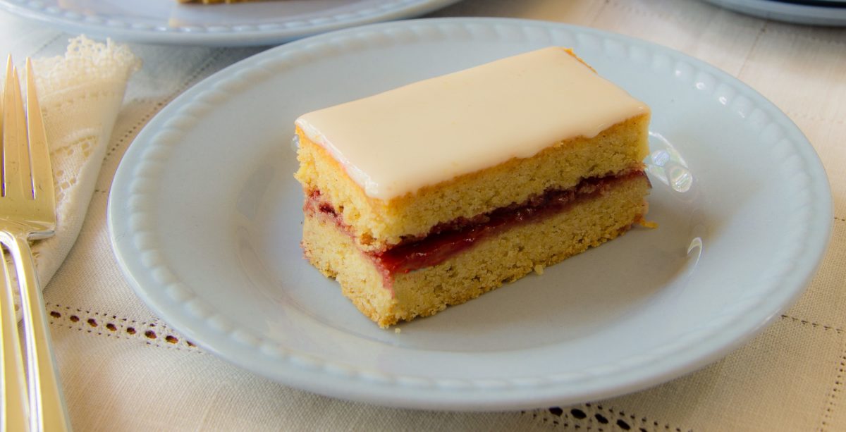Another angle of an Alexander cake piece on a white plate.