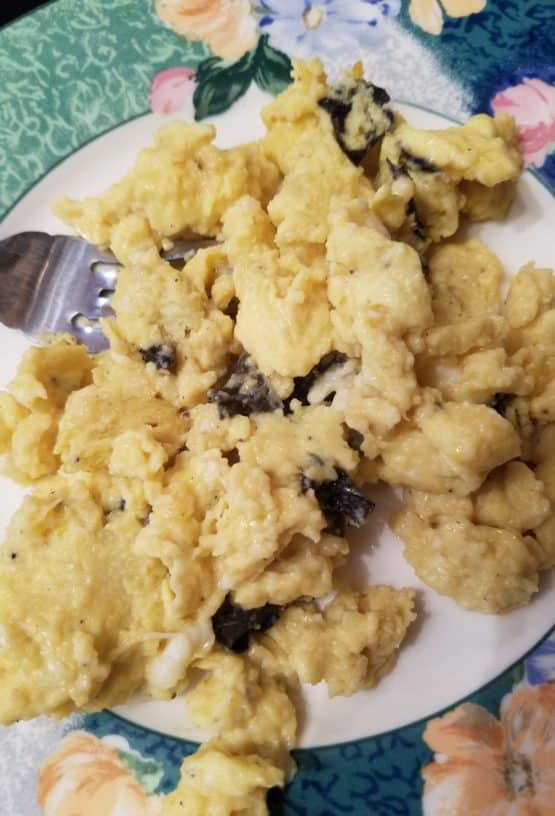 Floral plate with egg and black trumpet mushroom scramble