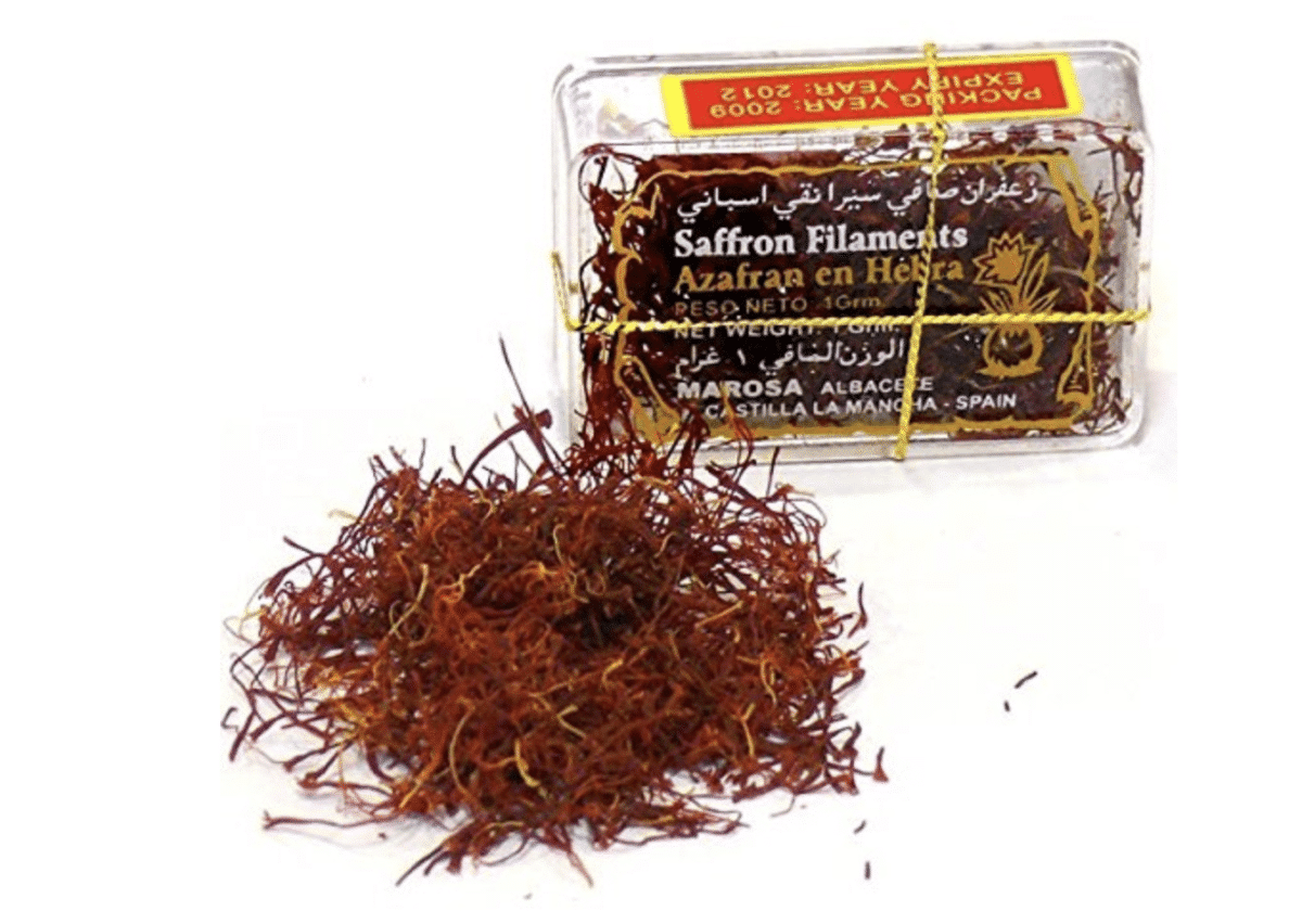 Box of saffron filaments with loose saffron.
