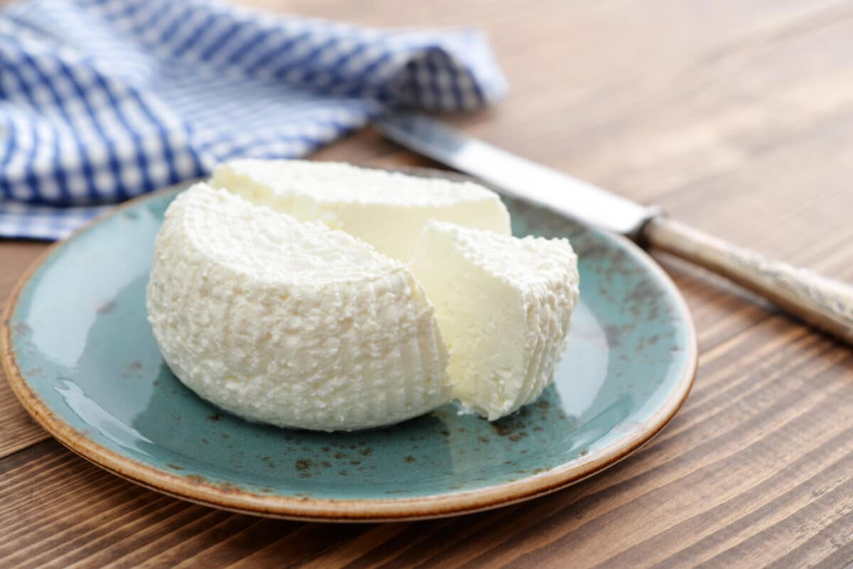 blue plate on table with ricotta cheese