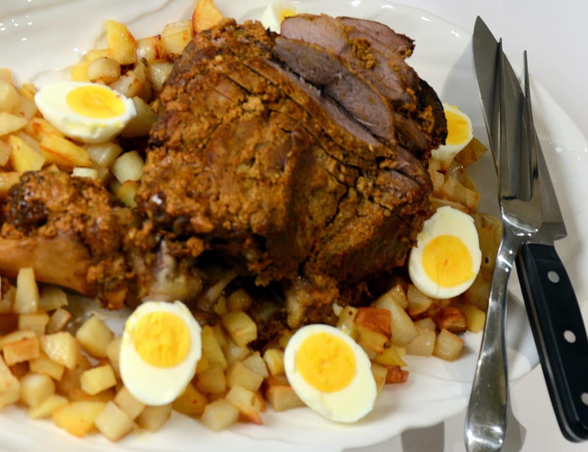 Tandoori-style roast leg of lamb served with potatoes and boiled eggs.